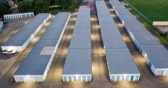 Aerial view of illuminated self storage units at Security Self Storage and Parking in Waxahachie, TX at dusk